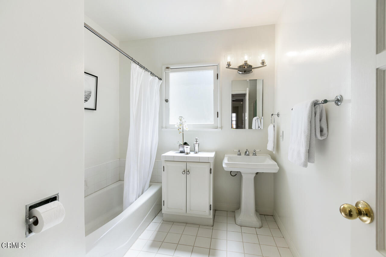 982 Athens Street Altadena, CA 91001 - Photo 15 of 25 a spacious bathroom with a bathtub sink and mirror