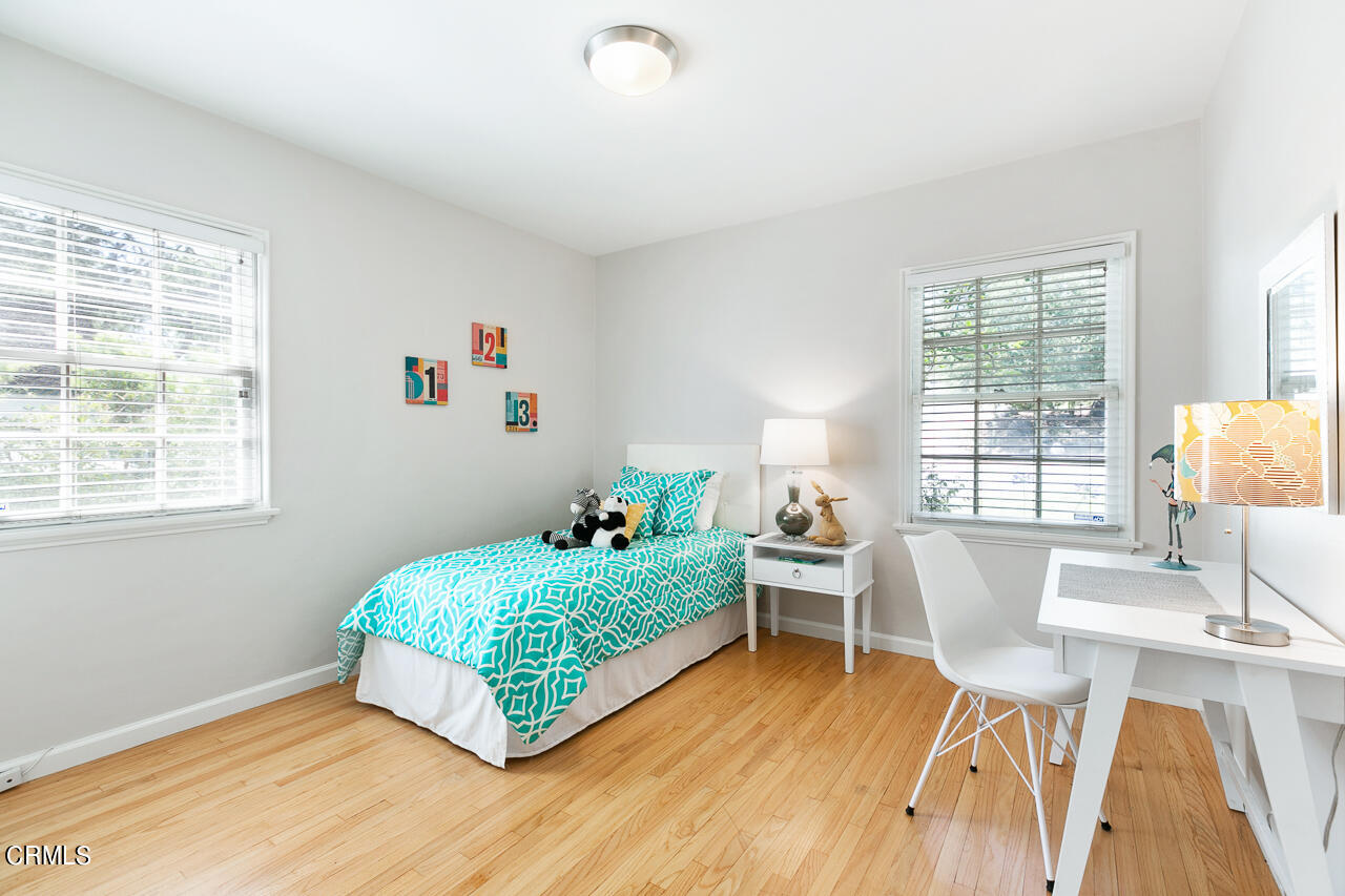 982 Athens Street Altadena, CA 91001 - Photo 16 of 25 a living room with a bed furniture and a large window
