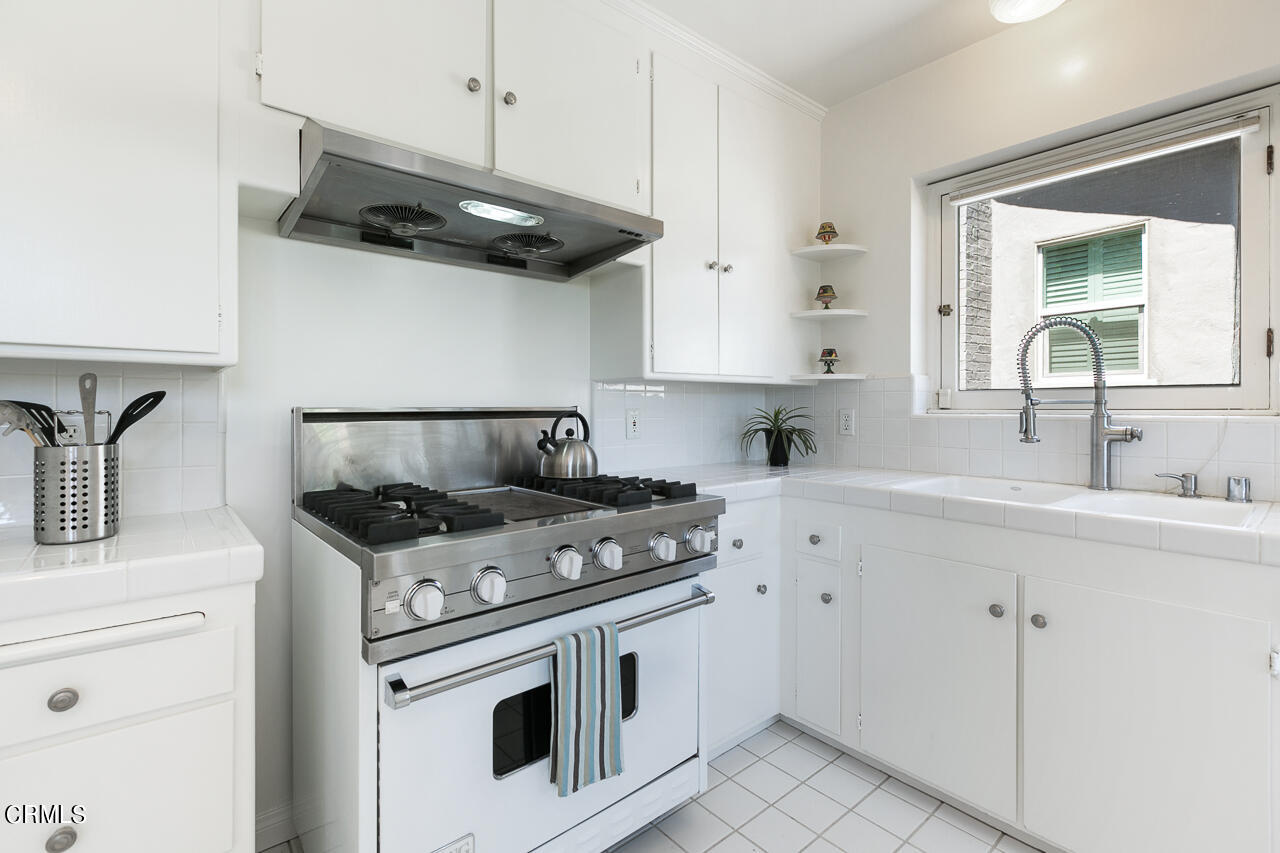 982 Athens Street Altadena, CA 91001 - Photo 8 of 25 a kitchen with stainless steel appliances granite countertop a sink a stove and cabinets