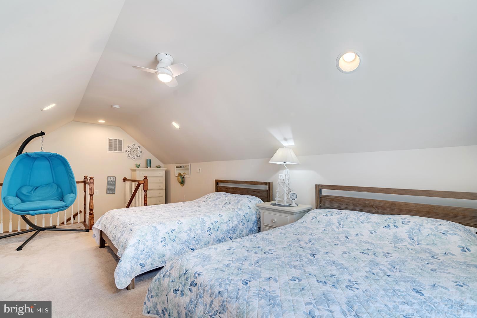34438 Spring Brook Avenue Lewes, DE 19958 - Photo 33 of 58 a bedroom with two beds and a chandelier