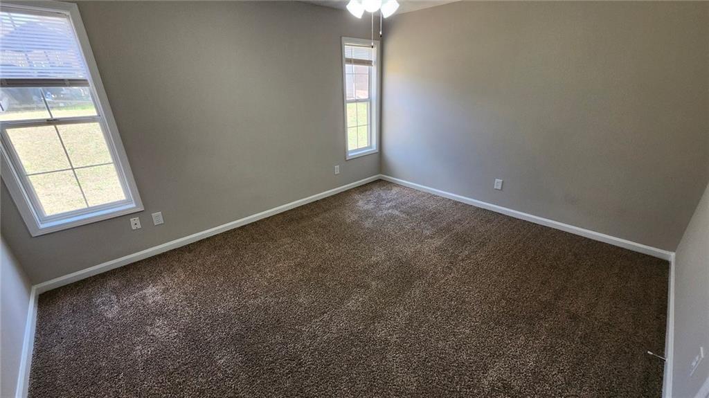 587 North Shore Road Lithonia, GA 30058 - Photo 11 of 16 an empty room with windows and closet
