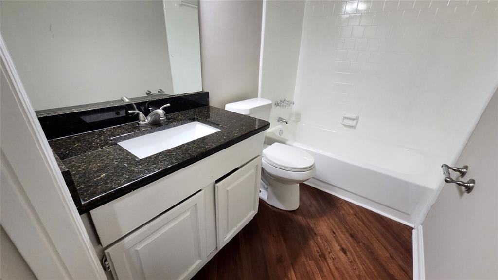 587 North Shore Road Lithonia, GA 30058 - Photo 12 of 16 a bathroom with a granite countertop sink and a mirror
