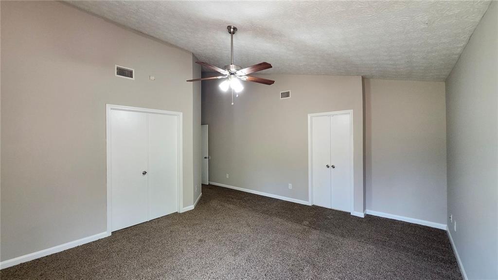 587 North Shore Road Lithonia, GA 30058 - Photo 7 of 16 a view of an empty room with a ceiling fan