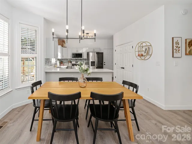 a view of a dining room with furniture large window and wooden floor