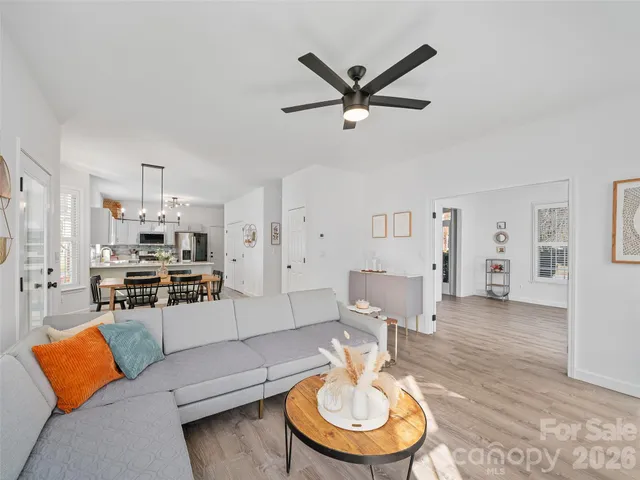 a living room with furniture and a dining table