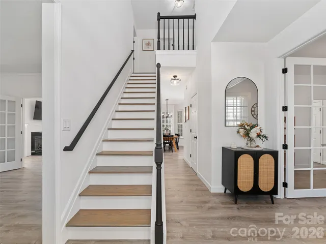 a view of entryway and hall with wooden floor