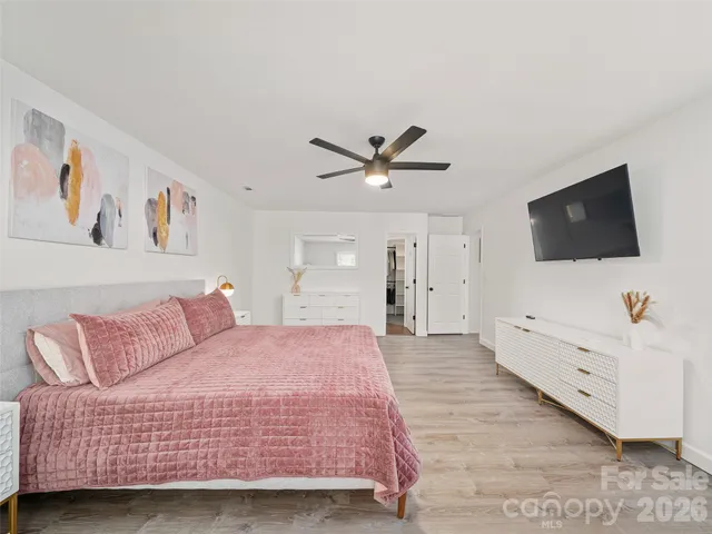 a bedroom with a bed and a flat screen tv