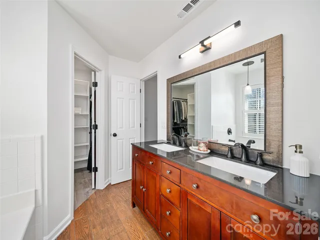 a spacious bathroom with a double vanity sink and a mirror