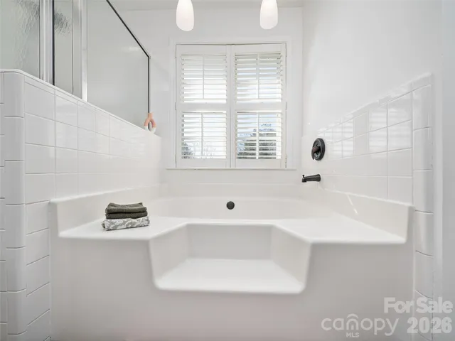 a bathroom with a bathtub and a window
