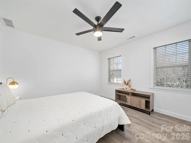 a spacious bedroom with a bed and window