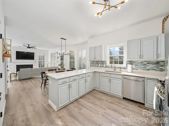 a open kitchen with sink cabinets and wooden floor