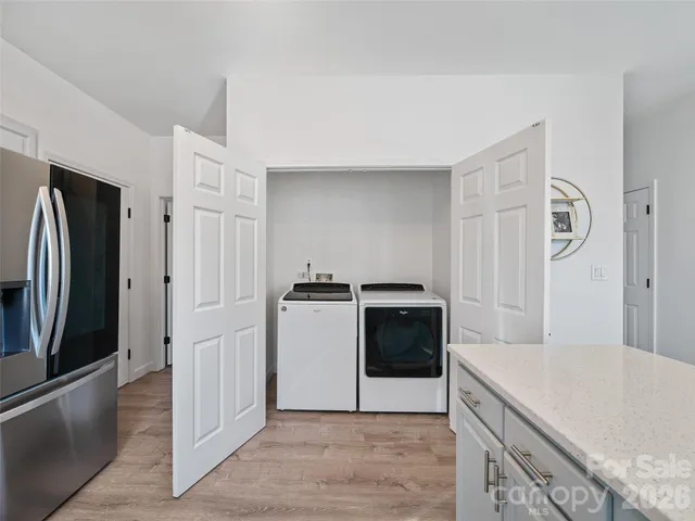 a kitchen with stainless steel appliances granite countertop a refrigerator and a stove