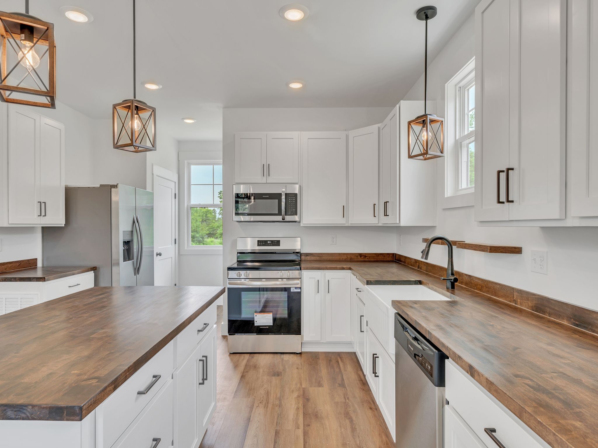5800 Sanders Road Lyles, TN 37098 - Photo 9 of 28 a kitchen with stainless steel appliances granite countertop a sink a stove top oven a counter space and cabinets