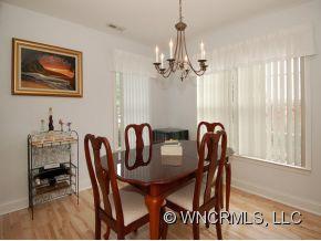 57 Round Top Road Asheville, NC 28803 - Photo 3 of 11 a view of a dining room with furniture window and wooden floor