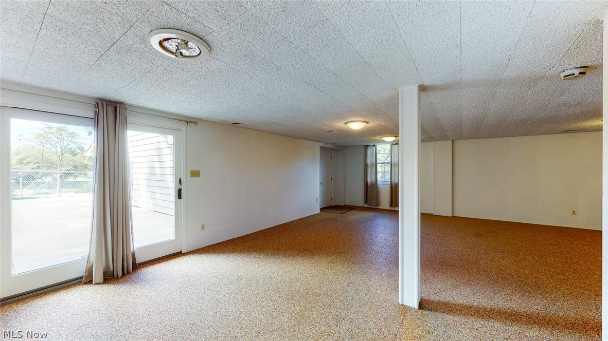 2938 Walnut Ridge Road Akron, OH 44333 - Photo 33 of 34 Recreation room (Nature Stone flooring) with access to the patio and garage.
