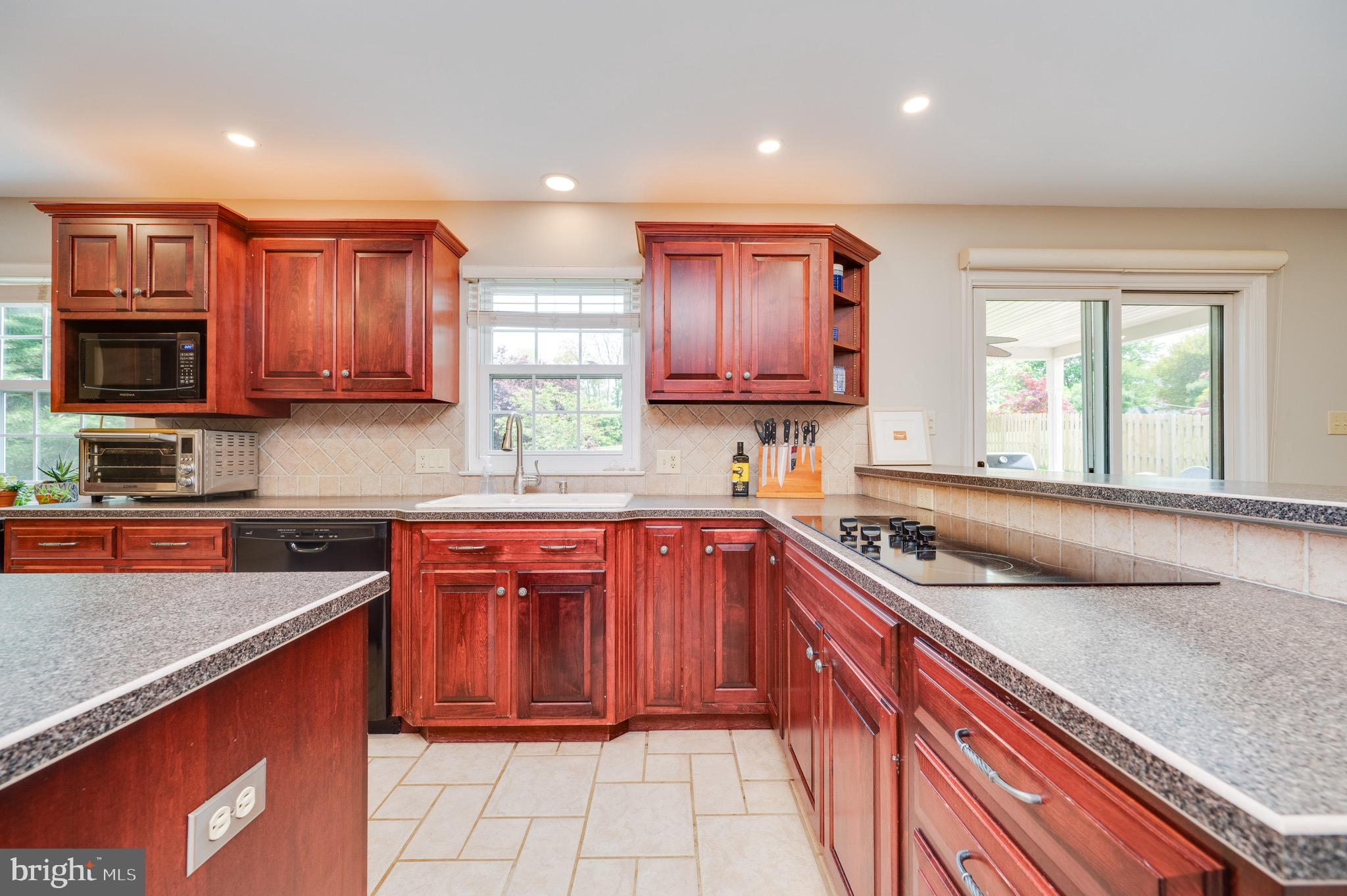 1 Flint Ridge Drive Reading, PA 19607 - Photo 8 of 49 a kitchen with stainless steel appliances granite countertop wooden cabinets a stove top oven a granite counter space and a window