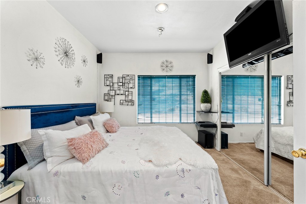 17234 Gamble Avenue Riverside, CA 92504 - Photo 20 of 56 a bedroom with a bed and glass window
