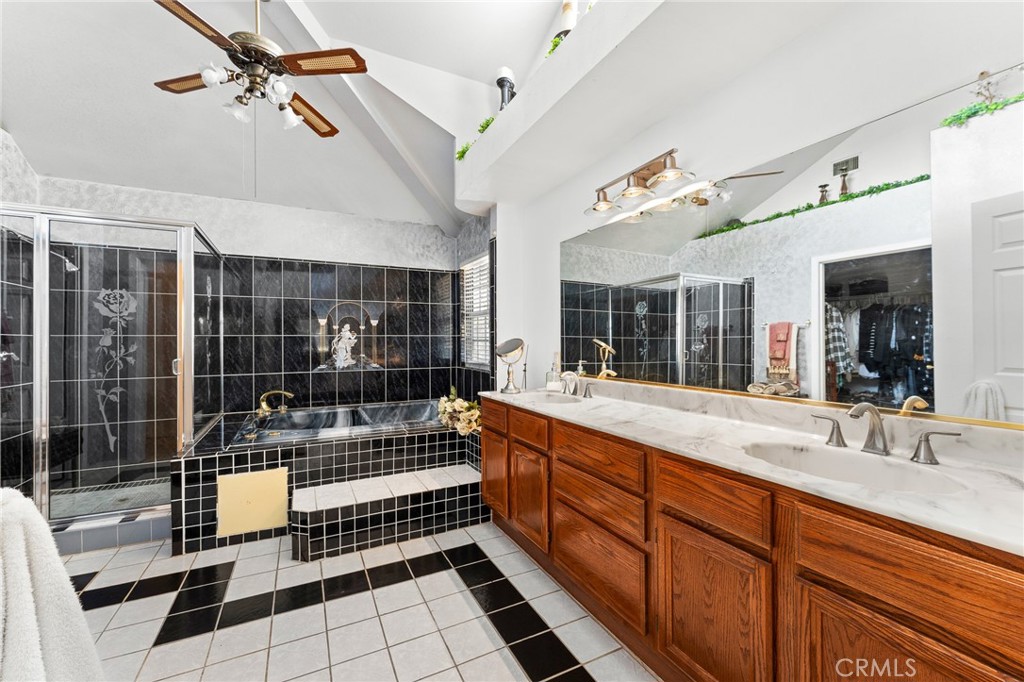17234 Gamble Avenue Riverside, CA 92504 - Photo 29 of 56 a large bathroom with a double vanity sink a mirror and a glass door