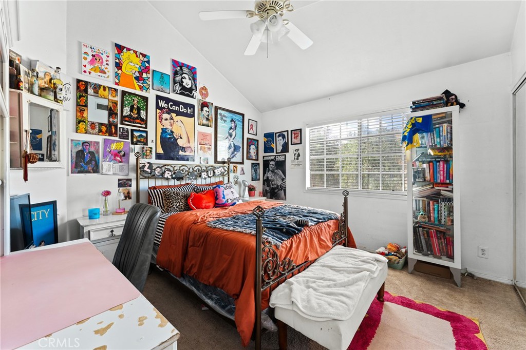 17234 Gamble Avenue Riverside, CA 92504 - Photo 34 of 56 a bed room with a bed and a book shelf