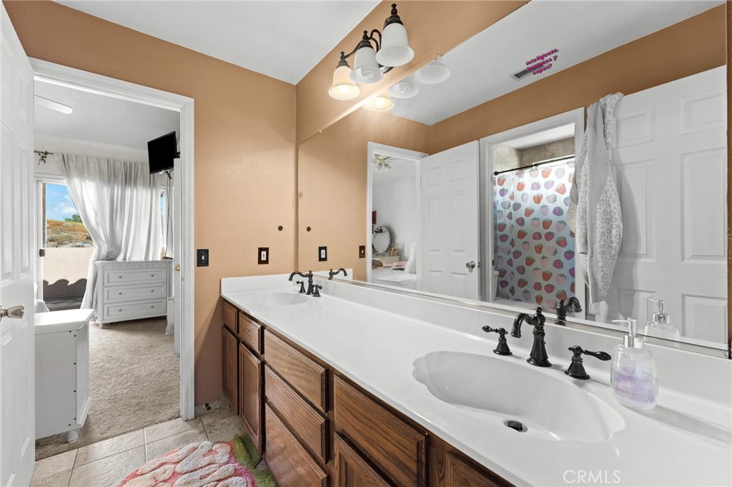 17234 Gamble Avenue Riverside, CA 92504 - Photo 35 of 56 a bathroom with a sink double vanity and a mirror