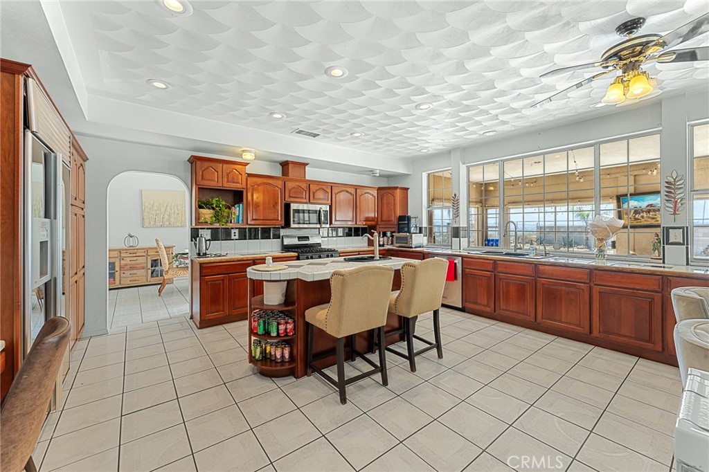 17234 Gamble Avenue Riverside, CA 92504 - Photo 5 of 56 a room with stainless steel appliances kitchen island granite countertop a sink and cabinets