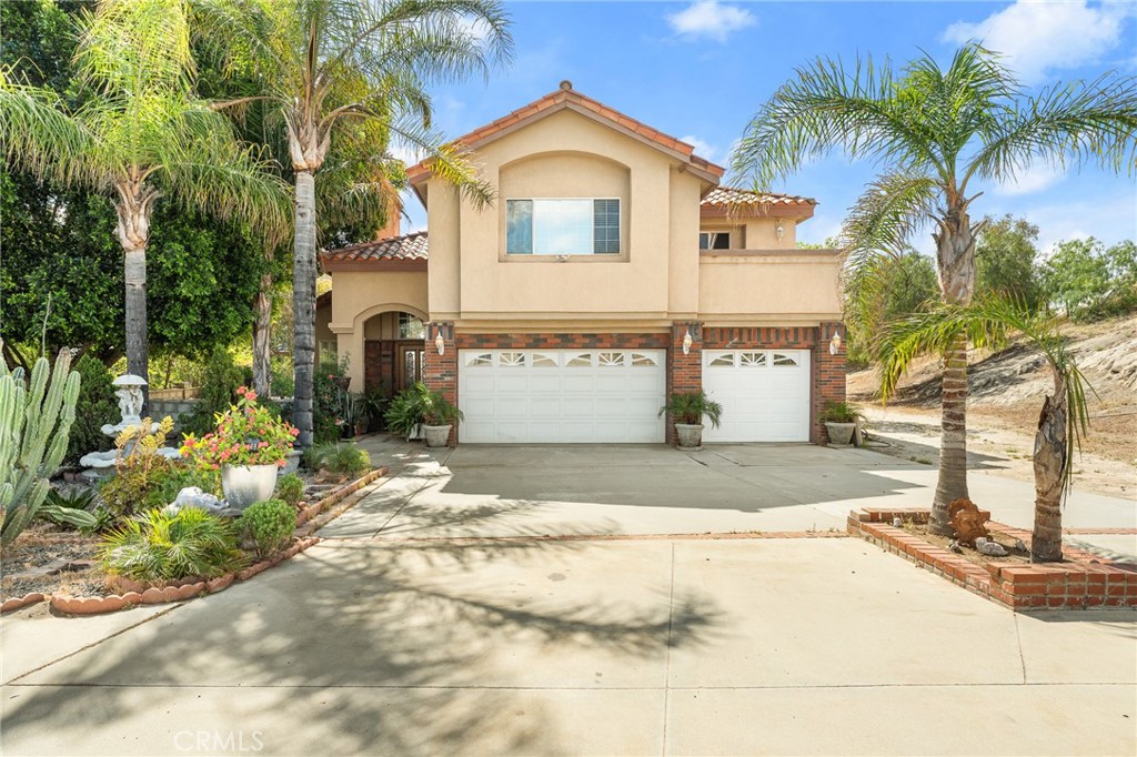17234 Gamble Avenue Riverside, CA 92504 - Photo 56 of 56 a front view of a house with a yard and garage