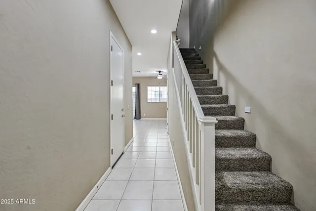 a view of a hallway with entryway and white walls