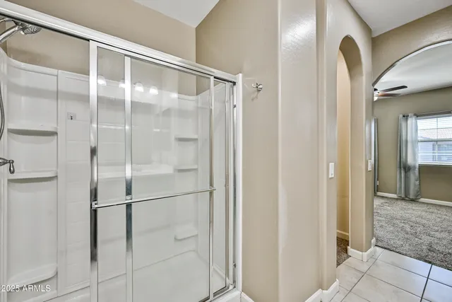 a bathroom with a glass shower door