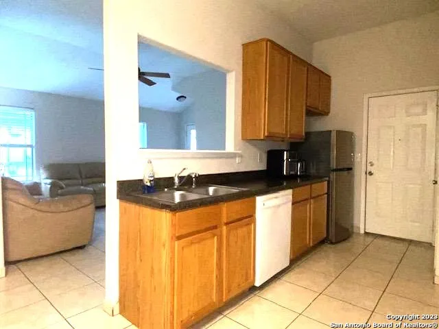 a kitchen with stainless steel appliances granite countertop a sink and a stove