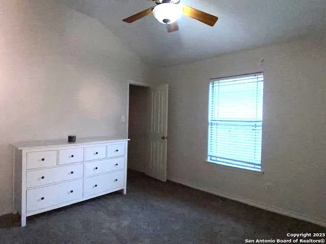 a room with dresser with window