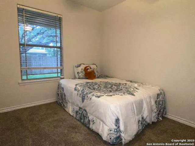 a large bed sitting in a bedroom next to a window