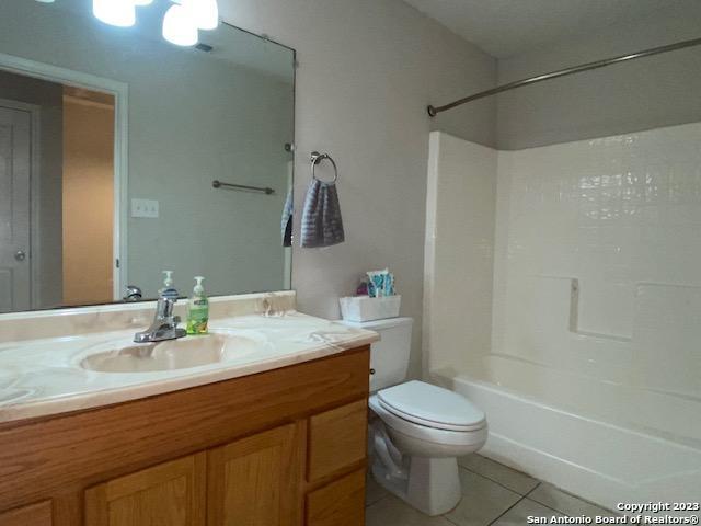 716 Uvalde Street, Unit B Pleasanton, TX 78064 - Photo 8 of 10 a bathroom with a sink a toilet and shower