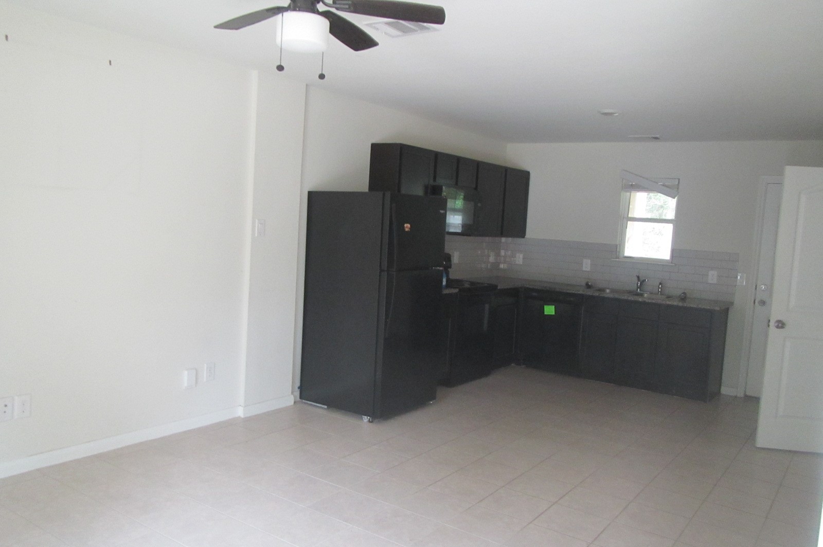 28612 Netawake Court Point Blank, TX 77364 - Photo 6 of 14 a kitchen with granite countertop a refrigerator and a sink