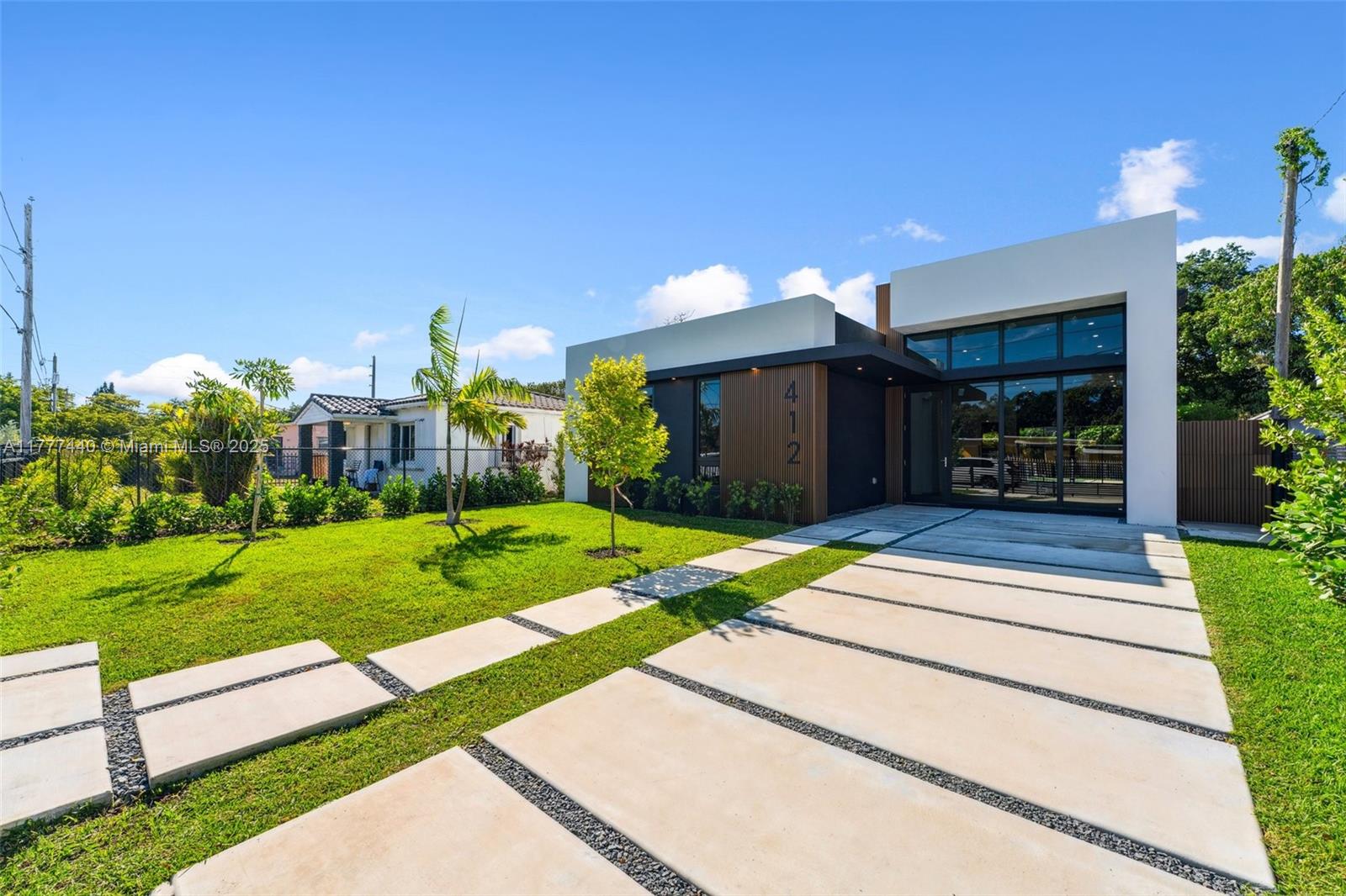 a front view of a house with a yard and a garage