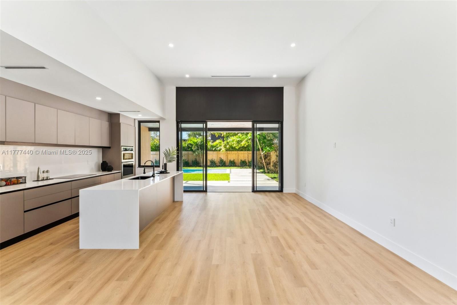 412 Northwest 47th Street Miami, FL 33127 - Photo 11 of 62 a large kitchen with wooden floor and stainless steel appliances