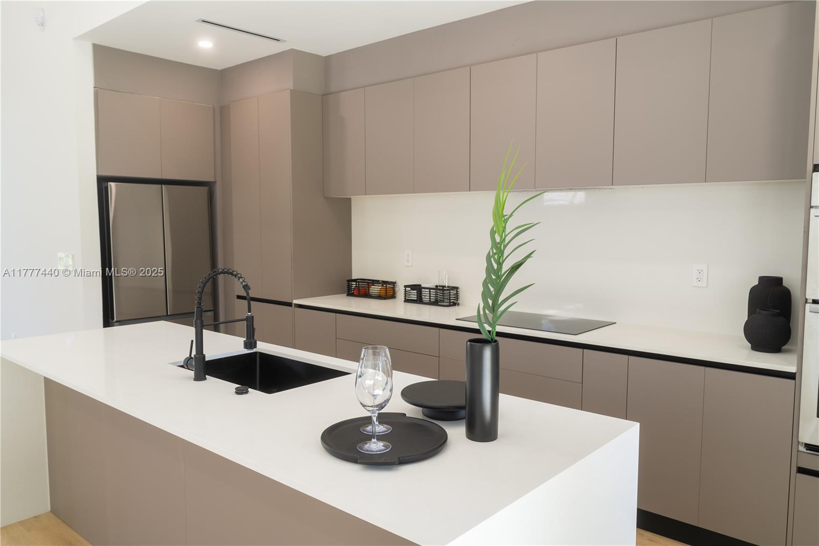 412 Northwest 47th Street Miami, FL 33127 - Photo 12 of 62 a kitchen with a sink and a refrigerator