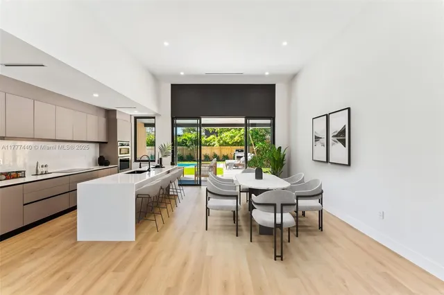 a kitchen with stainless steel appliances granite countertop a refrigerator and a stove top oven
