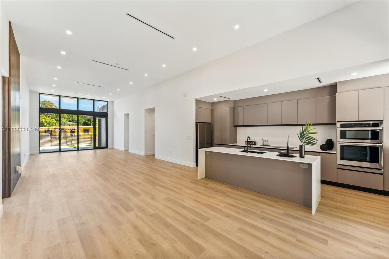 412 Northwest 47th Street Miami, FL 33127 - Photo 15 of 62 a kitchen with stainless steel appliances granite countertop a refrigerator and a stove top oven