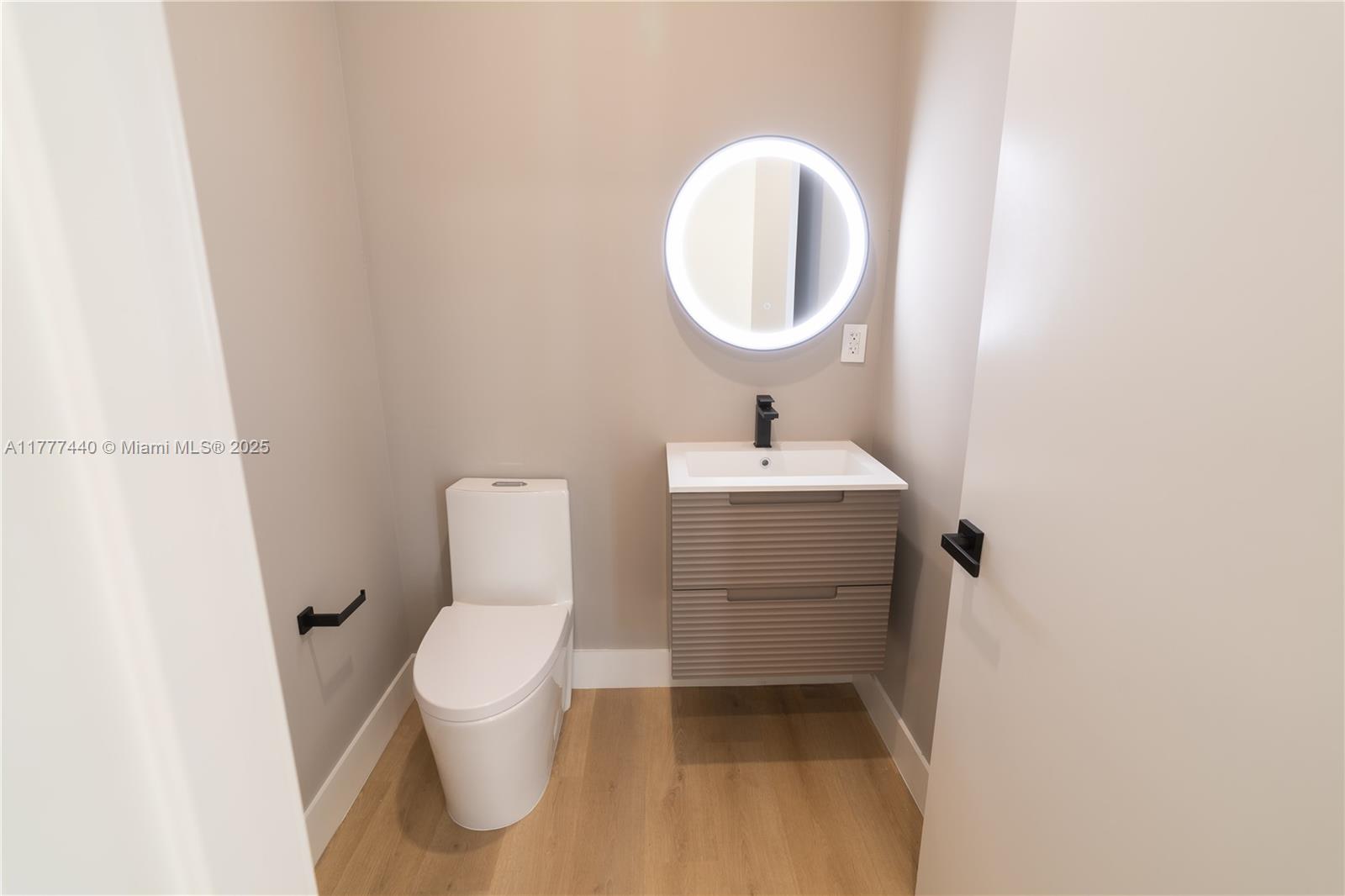 412 Northwest 47th Street Miami, FL 33127 - Photo 16 of 62 a bathroom with a toilet sink and mirror