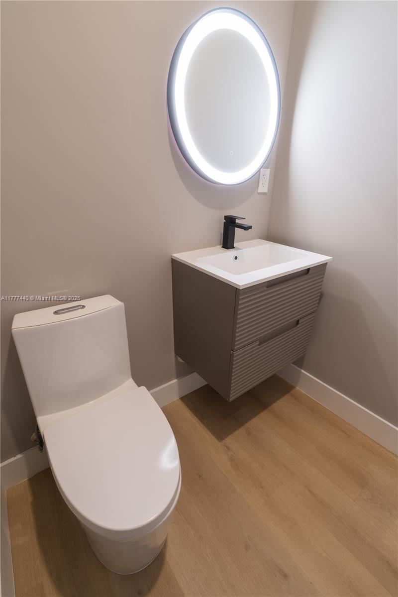 412 Northwest 47th Street Miami, FL 33127 - Photo 17 of 62 a bathroom with a sink mirror and toilet