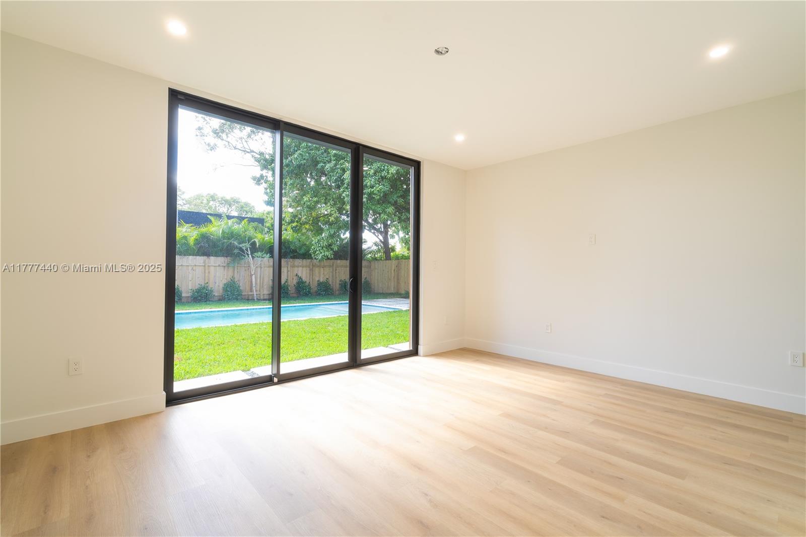 412 Northwest 47th Street Miami, FL 33127 - Photo 19 of 62 a view of an empty room with wooden floor and a window