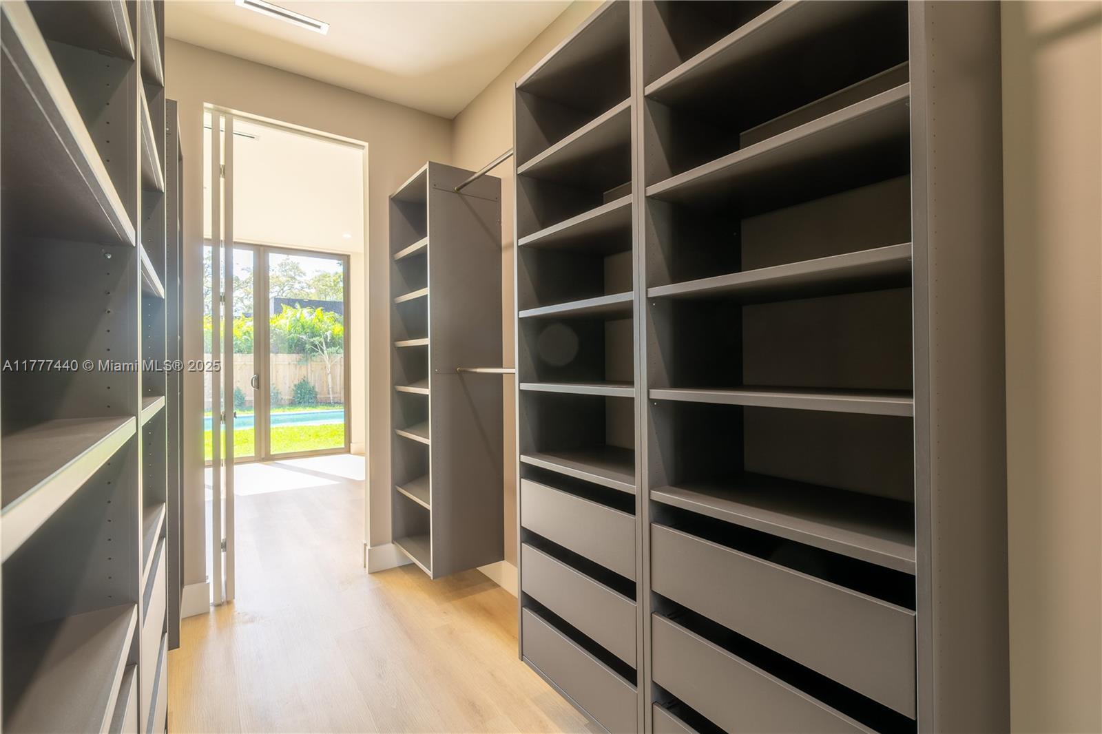 412 Northwest 47th Street Miami, FL 33127 - Photo 24 of 62 a view of walk in closet with empty racks