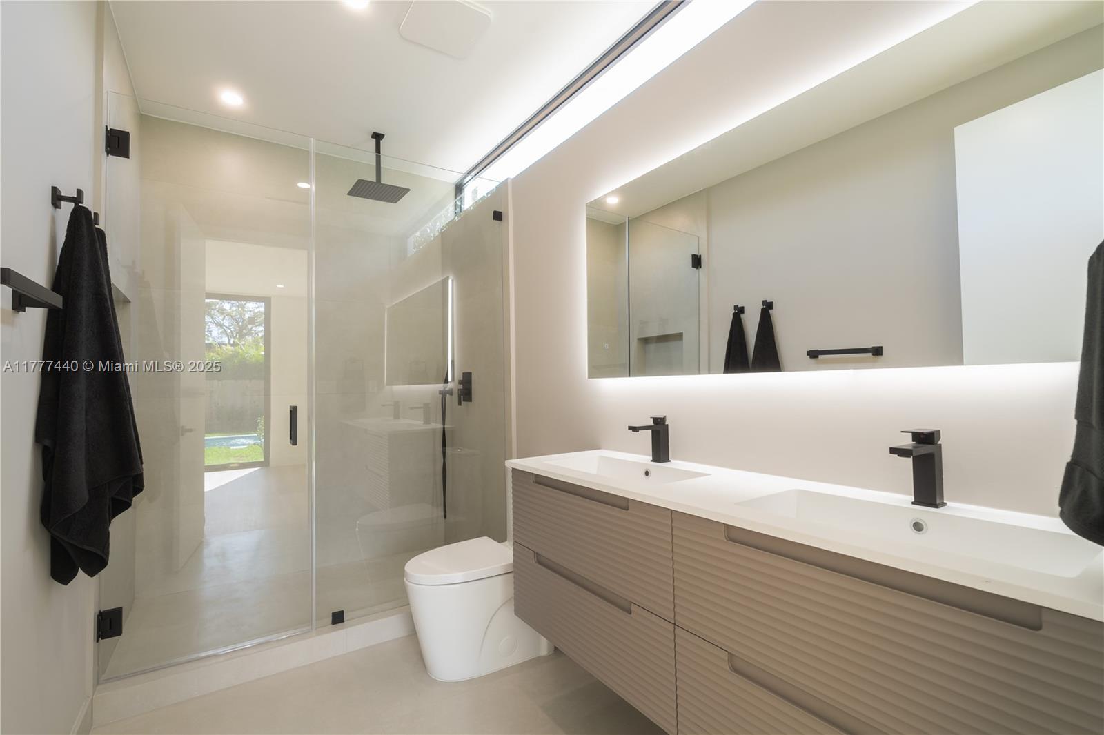 412 Northwest 47th Street Miami, FL 33127 - Photo 25 of 62 a bathroom with a double vanity sink toilet and shower