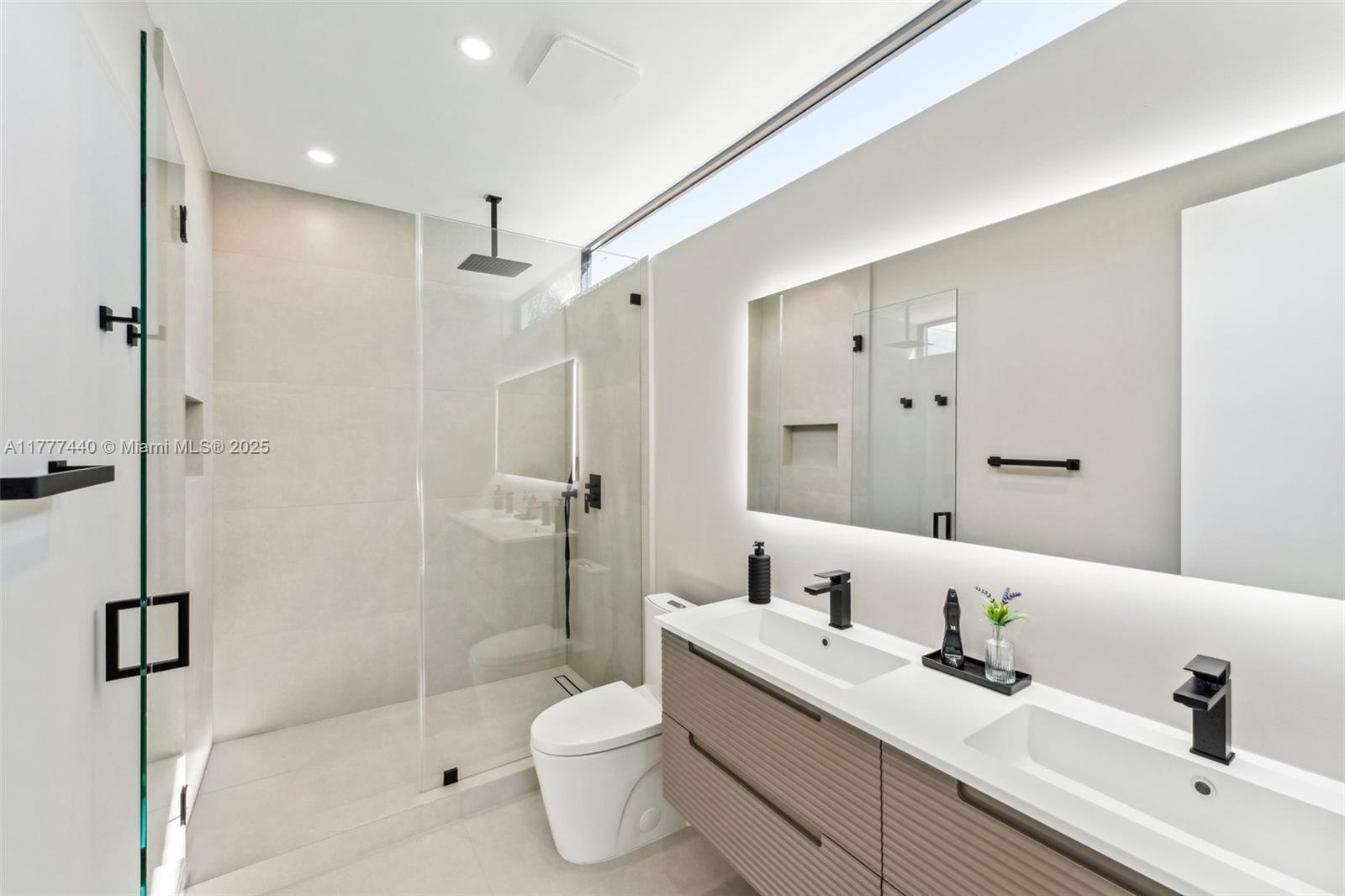 412 Northwest 47th Street Miami, FL 33127 - Photo 26 of 62 a bathroom with a sink a toilet and shower