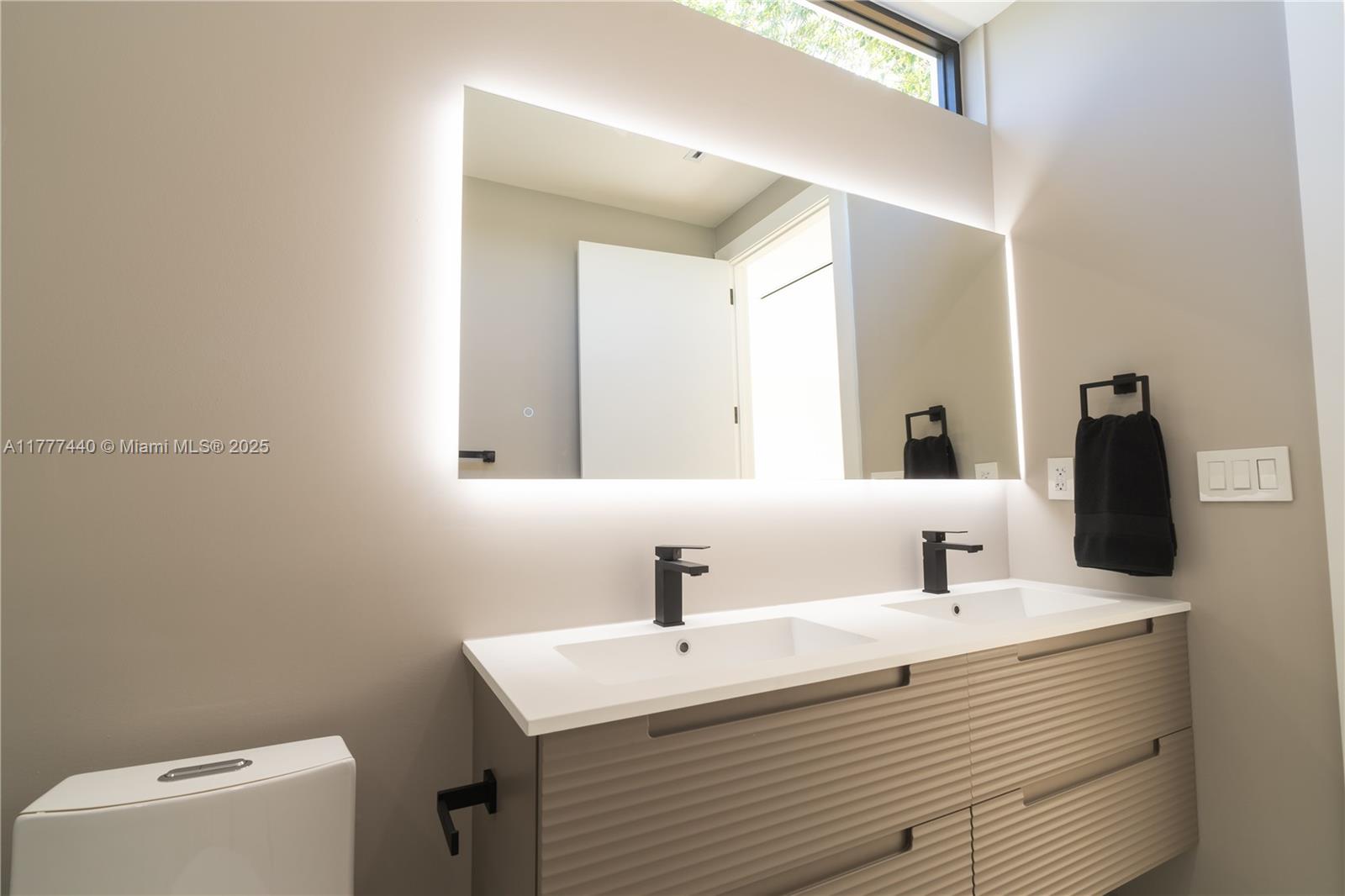 412 Northwest 47th Street Miami, FL 33127 - Photo 27 of 62 a bathroom with a sink and a mirror