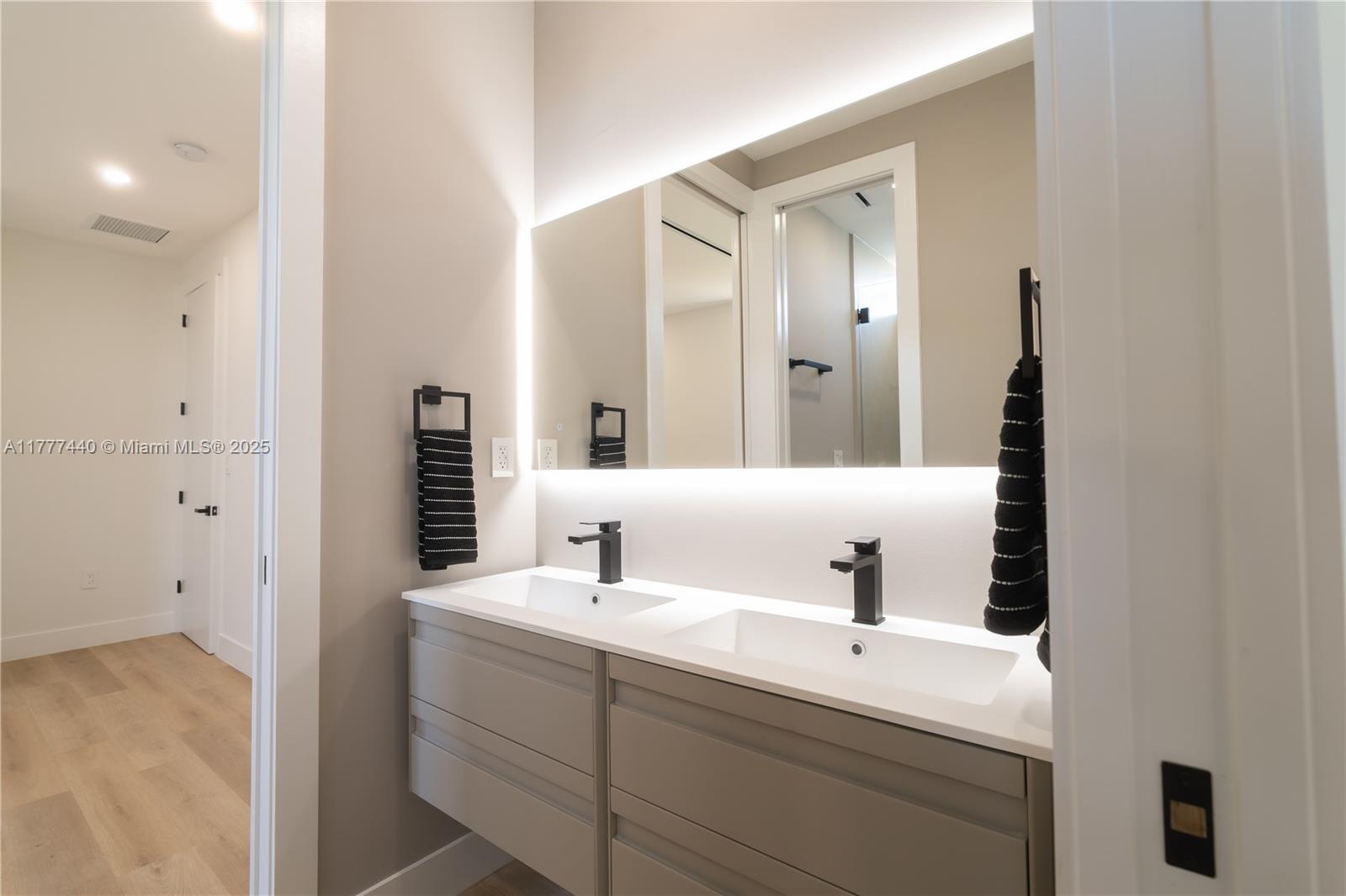 412 Northwest 47th Street Miami, FL 33127 - Photo 31 of 62 a bathroom with a sink and a mirror