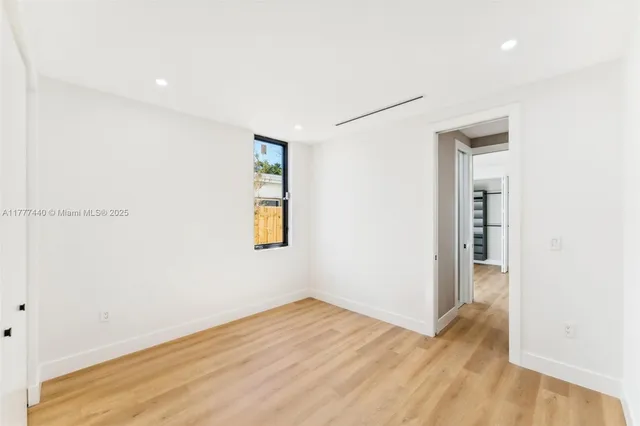 a bathroom with a toilet and a mirror