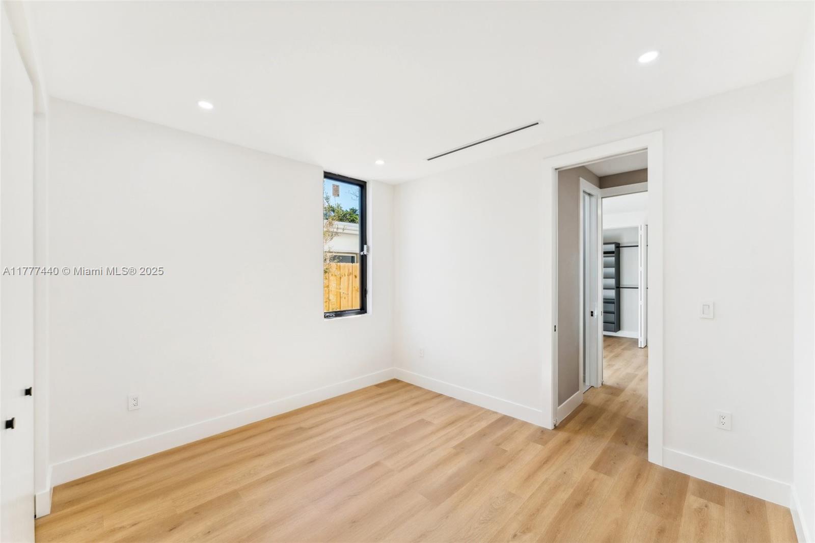 412 Northwest 47th Street Miami, FL 33127 - Photo 37 of 62 a view of an empty room with wooden floor and a window