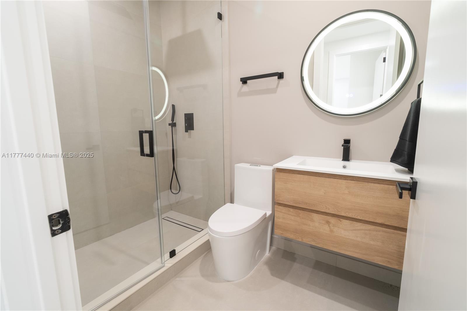 412 Northwest 47th Street Miami, FL 33127 - Photo 41 of 62 a bathroom with a toilet sink and a mirror