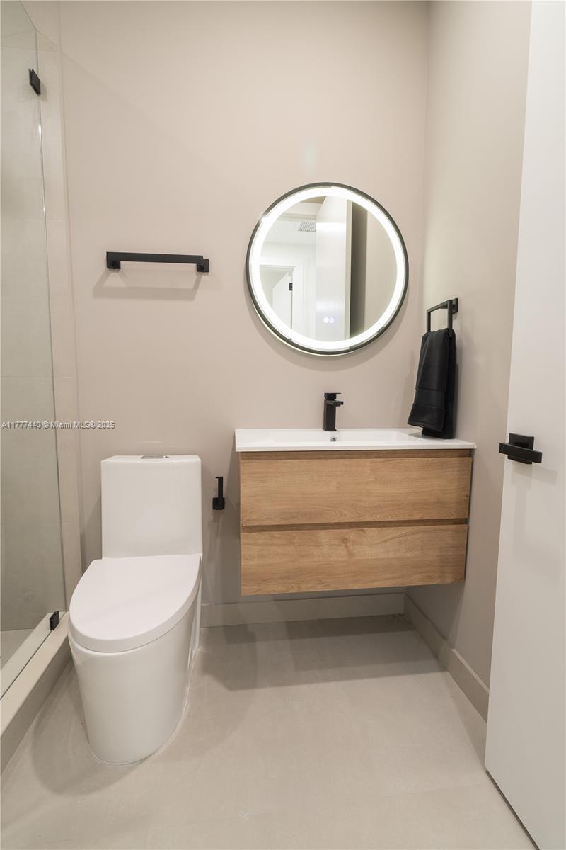 412 Northwest 47th Street Miami, FL 33127 - Photo 42 of 62 a bathroom with a toilet and a mirror